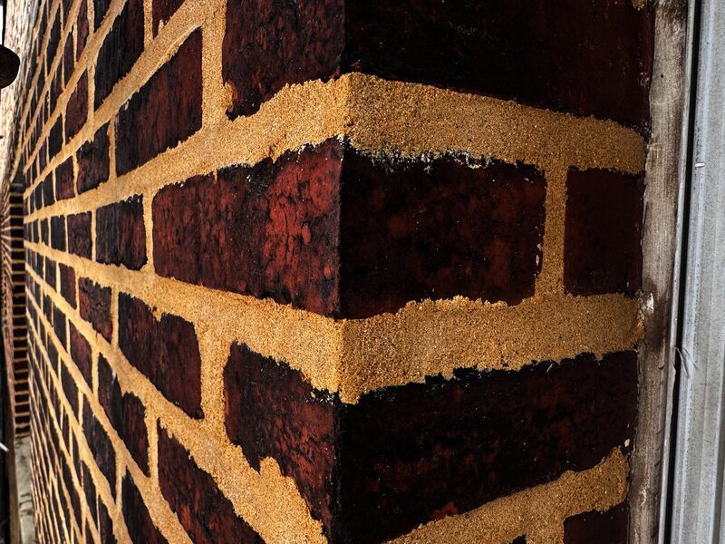 Close up of brick wall showing mortar joints that have been tuckpointed